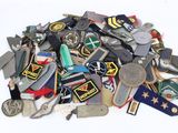a pile of assorted military badges on a white surface