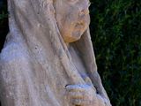 a statue of a woman with a hood on
