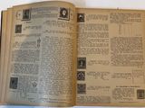 an open book with stamps on it sitting on a table