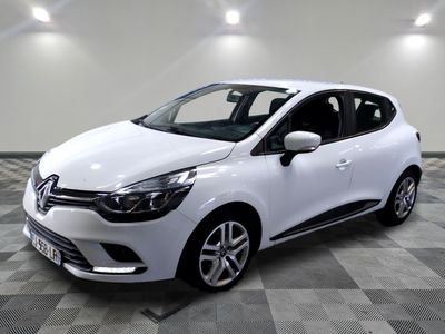 the white car is parked on a checkered tile floor