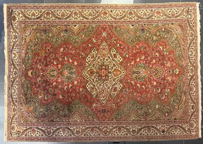 an antique persian rug with a red and green design