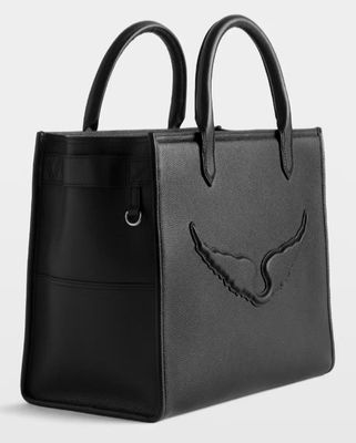 a black leather handbag with an eagle design on the front