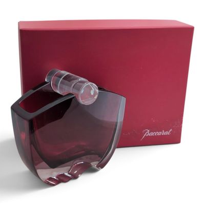 perfume bottle in a red box with a red box behind it