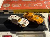 two toy cars that are sitting in a box