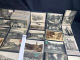 a lot of old black and white photos on the table