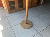 a wooden pole that is standing on a tile floor