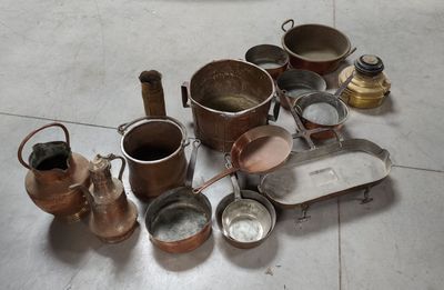many pots and pans on the floor next to each other