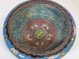 a blue bowl with a design on it on a white surface