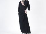 an image of a mannequin wearing a black dress with ruffles on it