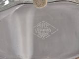 a silver vase with a brown handle on a table