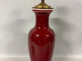 an image of a red vase with a gold top