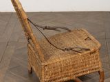 a wicker chair that is sitting on a tile floor