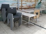 many chairs and tables in a room with a mural on the wall