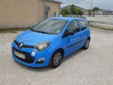 a small blue car parked in a parking lot