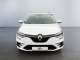the front view of a white car parked in a room