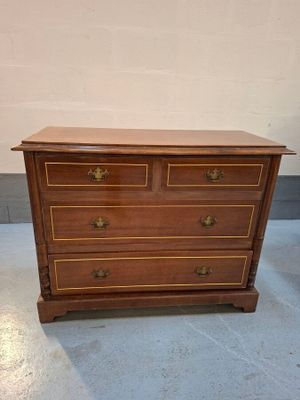a wooden chest of drawers with brass handles and drawers