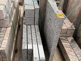 a large pile of granite blocks sitting on the ground