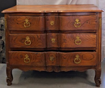 a wooden chest of drawers with gold handles on it