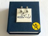 une photo d'une paire de boucles d'oreilles posées sur un livre