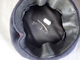 a black hat with a pair of scissors on top of it