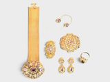 an image of a collection of gold jewelry on a white background