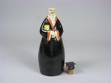 a figurine of a man with a graduation cap and gown