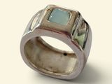 sterling silver ring with a green stone in the center