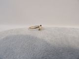 gros plan d'une bague en or sur une surface blanche