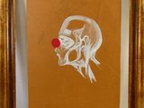 tableau représentant un clown au nez rouge, dans un cadre doré