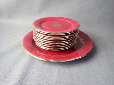 a stack of red plates on a plate on a table