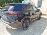 the back of a black toyota rav parked in front of a building
