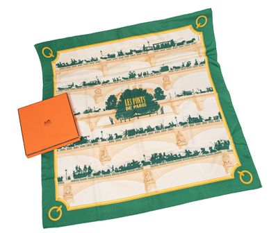 une boîte orange et une écharpe verte avec l'image d'un pont