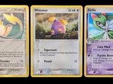 Trois cartes Pokémon différentes sont représentées sur un fond noir.