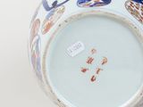 a close up of a vase on a white surface
