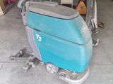 an image of a floor scruber in a garage