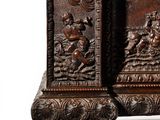 a wooden box with carvings on it on a white surface