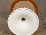 a white toilet with a wooden seat on the floor