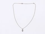 a silver necklace with a small diamond on a chain