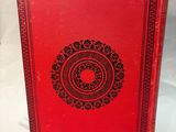 a red book sitting on top of a white table