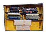 four toy trains in a box on a white background