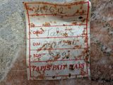 a piece of paper with writing on it sitting on a rock