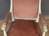 an antique chair with a red velvet upholstered seat