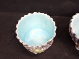 two bowls sitting next to each other on a black surface