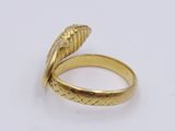 a close up of a gold ring on a white surface