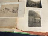 an open book with pictures of buildings on it sitting on a table
