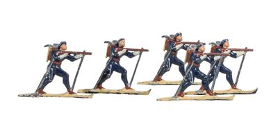 four figurines of a woman with skis and poles on a white background