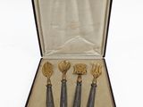four spoons and a fork in a case