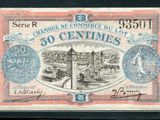 un ancien billet français de 50 centimes avec l'image d'un château en arrière-plan