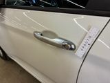 a sticker on the door handle of a white car