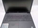 the laptop is open on a white surface with a blue keyboard